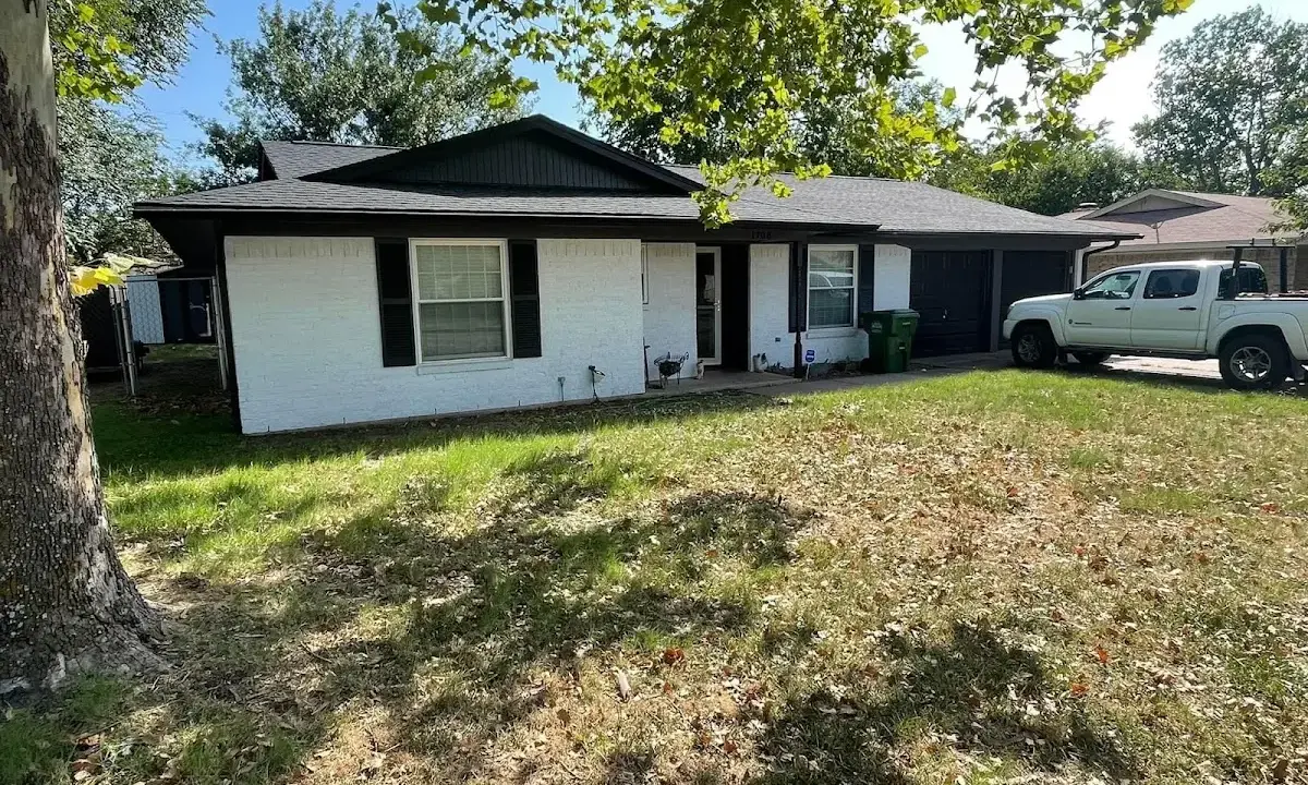 Professional roofing crew working on a residential roof in Granger